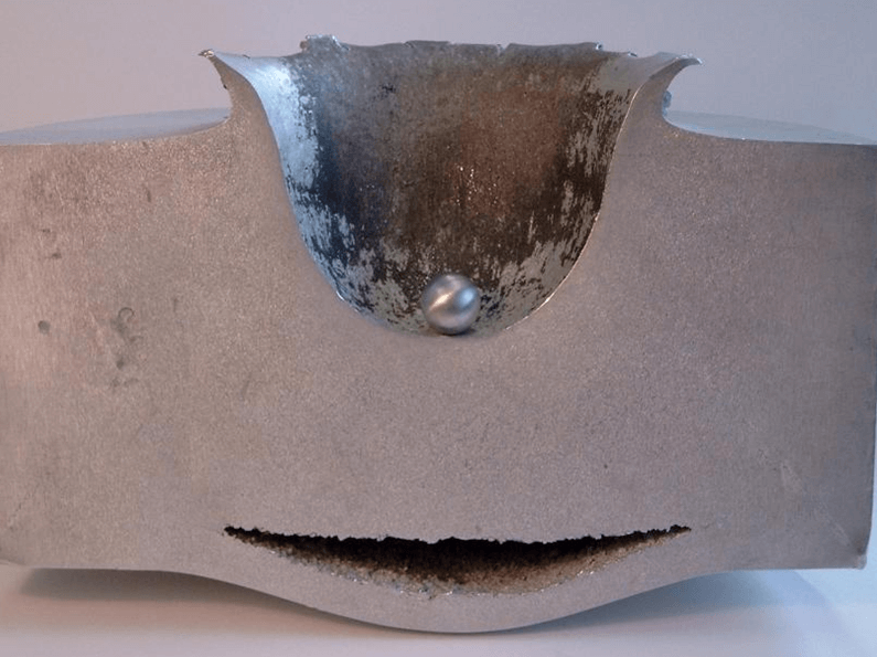 The result of hypervelocity impact testing by the European Space Agency, a crater in a huge block of metal..